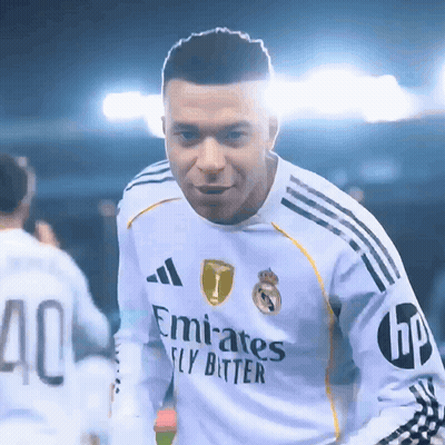 A Soccer Player Wearing A White Emirates Fly Bitter Jersey GIF
