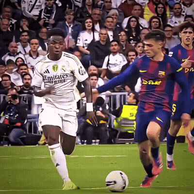 A Soccer Player Wearing A White Emirates Jersey Is Dribbling A Ball GIF
