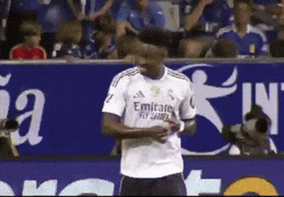 A Soccer Player Wearing A White Emirates Jersey Stands On The Field GIF