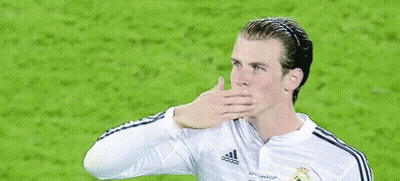 A Soccer Player Wearing A White Fly Emirates Jersey Is Waving His Hand . GIF