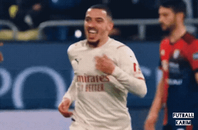 A Soccer Player Wearing A White Jersey That Says Emirates Fly Better GIF