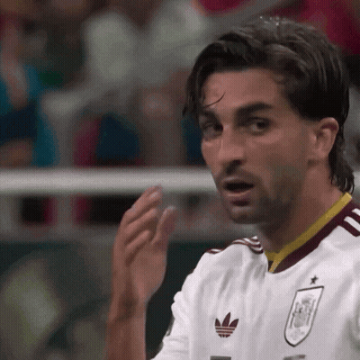 a soccer player wearing a white jersey with an adidas logo