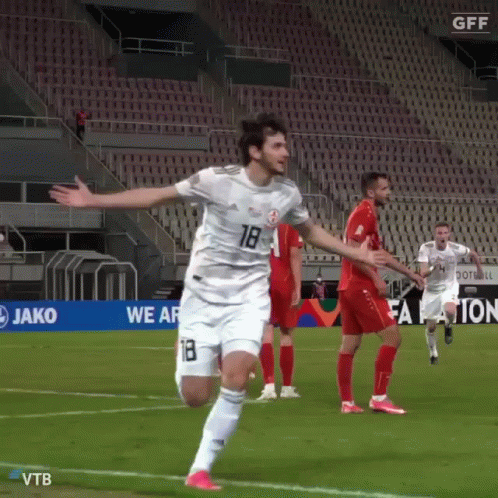 A Soccer Player Wearing A White Jersey With The Number 18 On It GIF