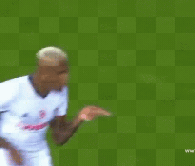 A Soccer Player Wearing A White Jersey With The Word Vodafone On It Is Running On The Field . GIF