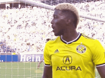 A Soccer Player Wearing A Yellow Acura Jersey GIF