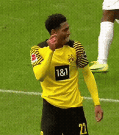 A Soccer Player Wearing A Yellow And Black Jersey With The Number 22 On It Is Standing On A Field . GIF