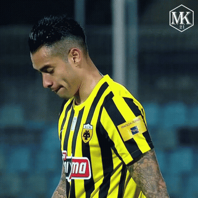 A Soccer Player Wearing A Yellow And Black Striped Shirt Has A Tattoo On His Arm That Says Mk On It GIF