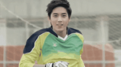 A Soccer Player Wearing A Yellow And Green Jersey With A X On It GIF