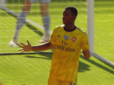 A Soccer Player Wearing A Yellow Fly Emirates Jersey Stands On The Field GIF