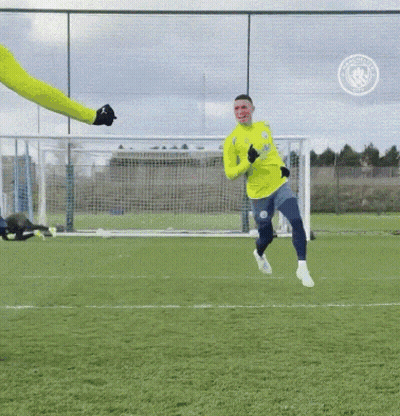 A Soccer Player Wearing A Yellow Jersey That Says Manchester City On It GIF