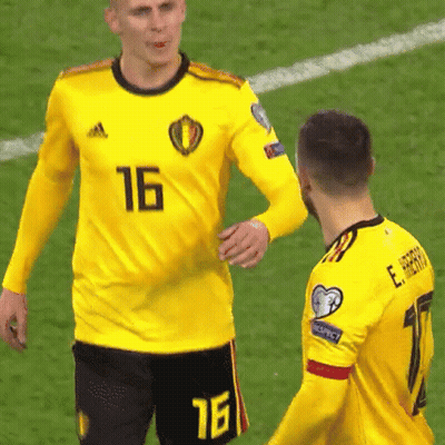 A Soccer Player Wearing A Yellow Jersey With The Number 16 On It Talks To Another Player GIF