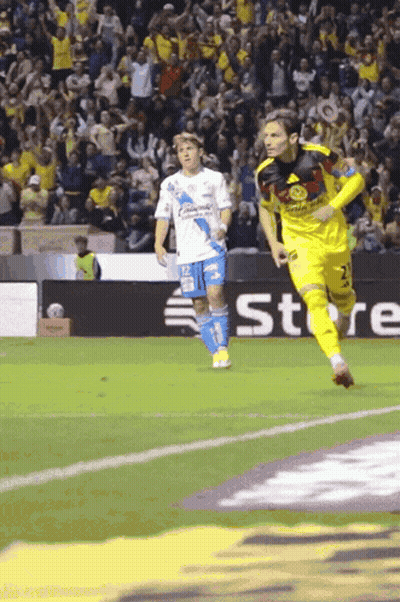 A Soccer Player Wearing A Yellow Jersey With The Number 2 On It Is Running On The Field GIF