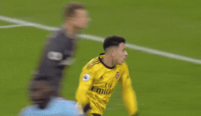 A Soccer Player Wearing A Yellow Jersey With The Number 3 On It Is Kicking The Ball . GIF