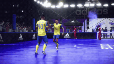 A Soccer Player Wearing A Yellow Jersey With The Number 40 On It Celebrates With Another Player GIF