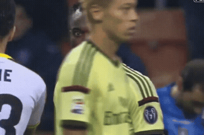A Soccer Player Wearing A Yellow Jersey With The Word Emirates On It GIF