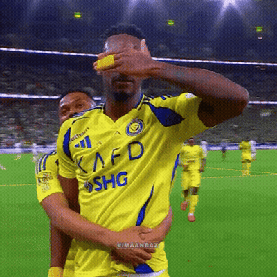 A Soccer Player Wearing A Yellow Kafd Shg Jersey Covers His Eyes GIF