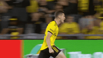 A Soccer Player Wearing A Yellow Shirt And Black Shorts GIF