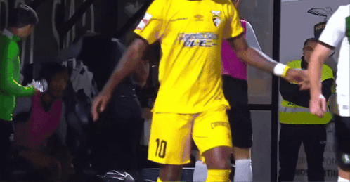 A Soccer Player Wearing A Yellow Uniform With The Number 10 On It GIF