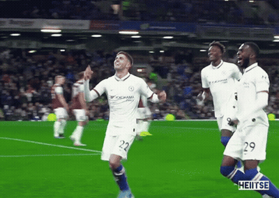 A Soccer Player Wearing A Yokohama Jersey Is Celebrating With His Teammates GIF