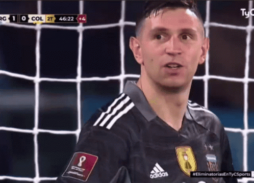 A Soccer Player Wearing An Adidas Jersey Looks At The Camera GIF