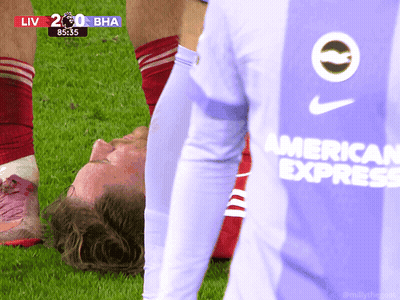 A Soccer Player Wearing An American Express Jersey Is Laying On The Field GIF