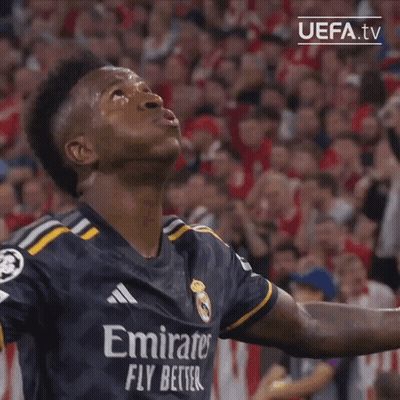 A Soccer Player Wearing An Emirates Fly Better Jersey Looks Up At The Sky GIF