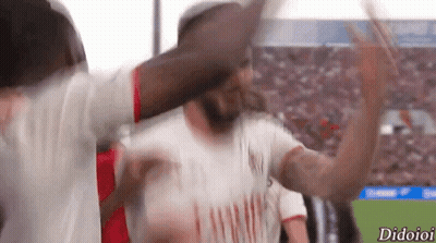 A Soccer Player Wearing An Emirates Shirt Is Celebrating With His Team GIF