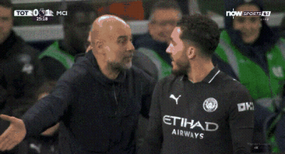 A Soccer Player Wearing An Etihad Airways Jersey Stands In Front Of A Lion GIF