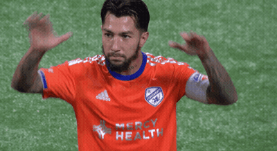 A Soccer Player Wearing An Orange Jersey That Says Mercy Health On It GIF