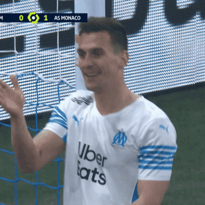 A Soccer Player Wearing An Uber Eats Shirt Waves His Hand GIF