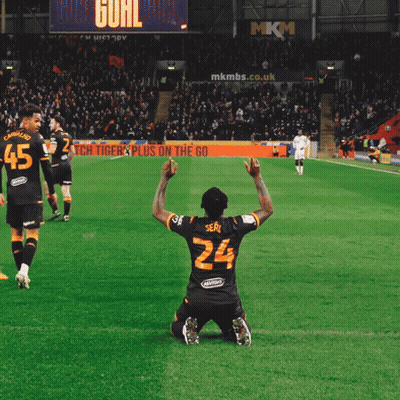 a soccer player wearing number 24 kneeling on the field