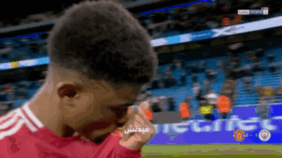 A Soccer Player Wipes His Eyes With His Hand In Front Of A Banner That Says ' Tiger ' On It GIF