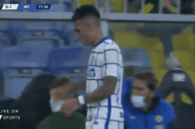 A Soccer Player With A Bandage On His Arm Is Being Helped By A Man Wearing A Mask . GIF