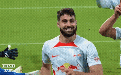 A Soccer Player With A Red Bull On His Shirt Is Smiling GIF