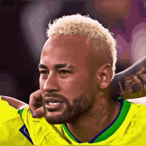 A Soccer Player With Blonde Hair And A Beard Is Wearing A Yellow Shirt . GIF