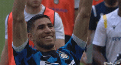 A Soccer Player With His Arms In The Air Is Wearing A Jersey That Says Smiley 1932 On It GIF