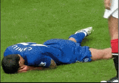 A Soccer Player With The Name Cahill On His Jersey Is Laying On The Ground GIF