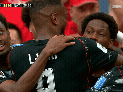 A Soccer Player With The Number 0 On His Jersey Is Hugging Another Player During A Game GIF
