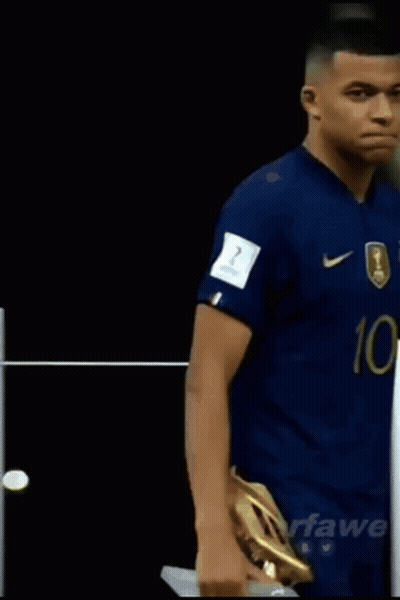 A Soccer Player With The Number 10 On His Jersey Is Holding A Golden Boot GIF