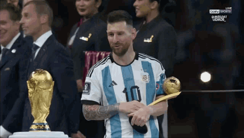 A Soccer Player With The Number 10 On His Jersey Is Holding A Trophy GIF