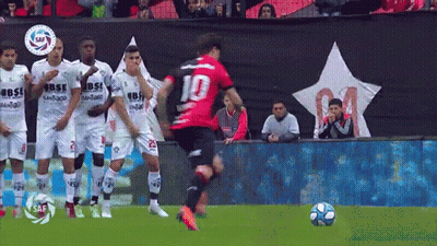 A Soccer Player With The Number 10 On His Jersey Is Kicking The Ball GIF