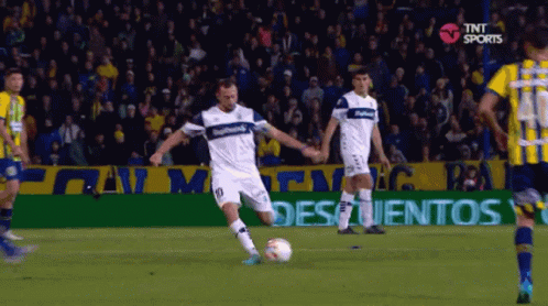 A Soccer Player With The Number 10 On His Jersey Is Kicking The Ball GIF