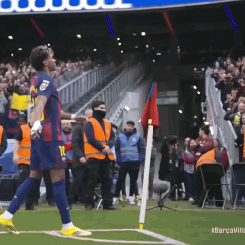 A Soccer Player With The Number 10 On His Jersey Stands On The Field GIF
