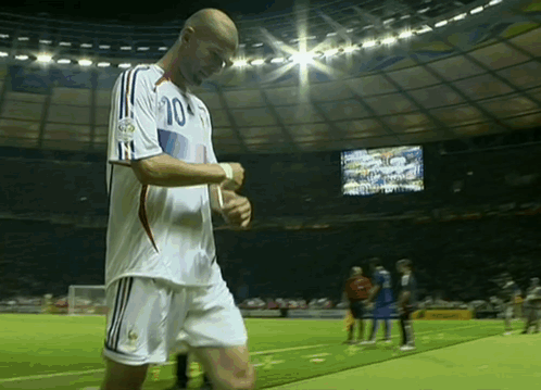 A Soccer Player With The Number 10 On His Jersey Stands On The Field GIF