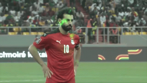 A Soccer Player With The Number 10 On His Jersey Stands On The Field GIF