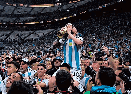 A Soccer Player With The Number 10 On His Shorts Holds A Trophy In His Mouth GIF