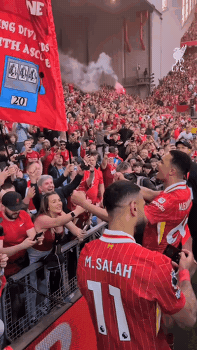 A Soccer Player With The Number 11 On His Back Is Surrounded By Fans GIF
