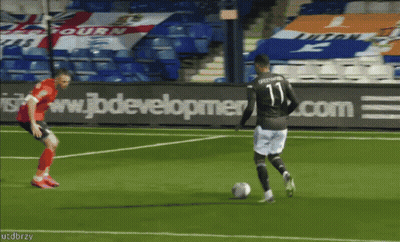 A Soccer Player With The Number 11 On His Jersey Is Kicking The Ball GIF
