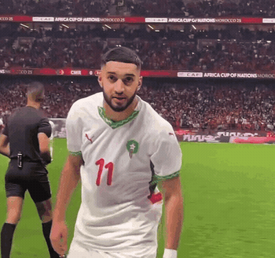 A Soccer Player With The Number 11 On His Jersey Stands On The Field GIF