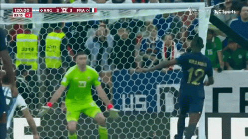 A Soccer Player With The Number 12 On His Jersey Is Getting Ready To Kick The Ball GIF